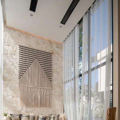Image of a Double-Height Living Room, featuring Stone Accent Wall and Floor-to-Ceiling Windows.
