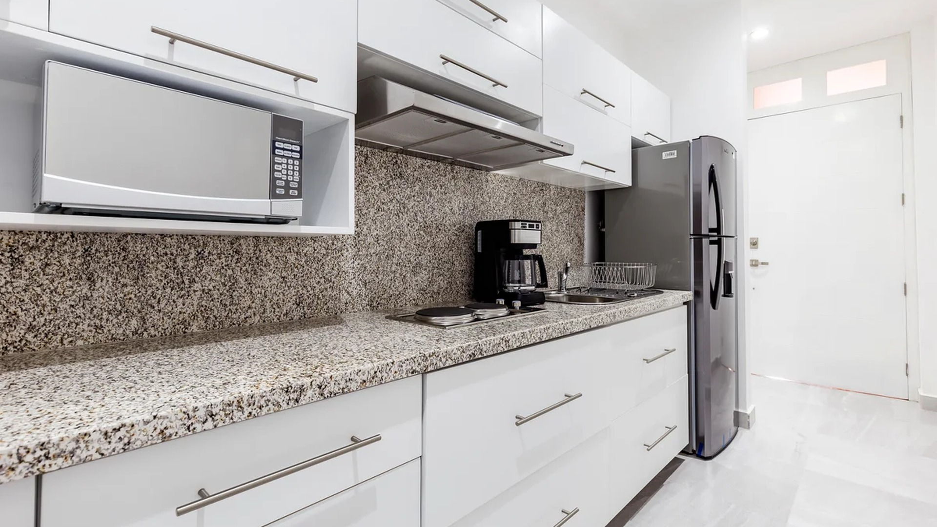 Image of a Modern Kitchen, featuring Granite Countertops and White Cabinetry.