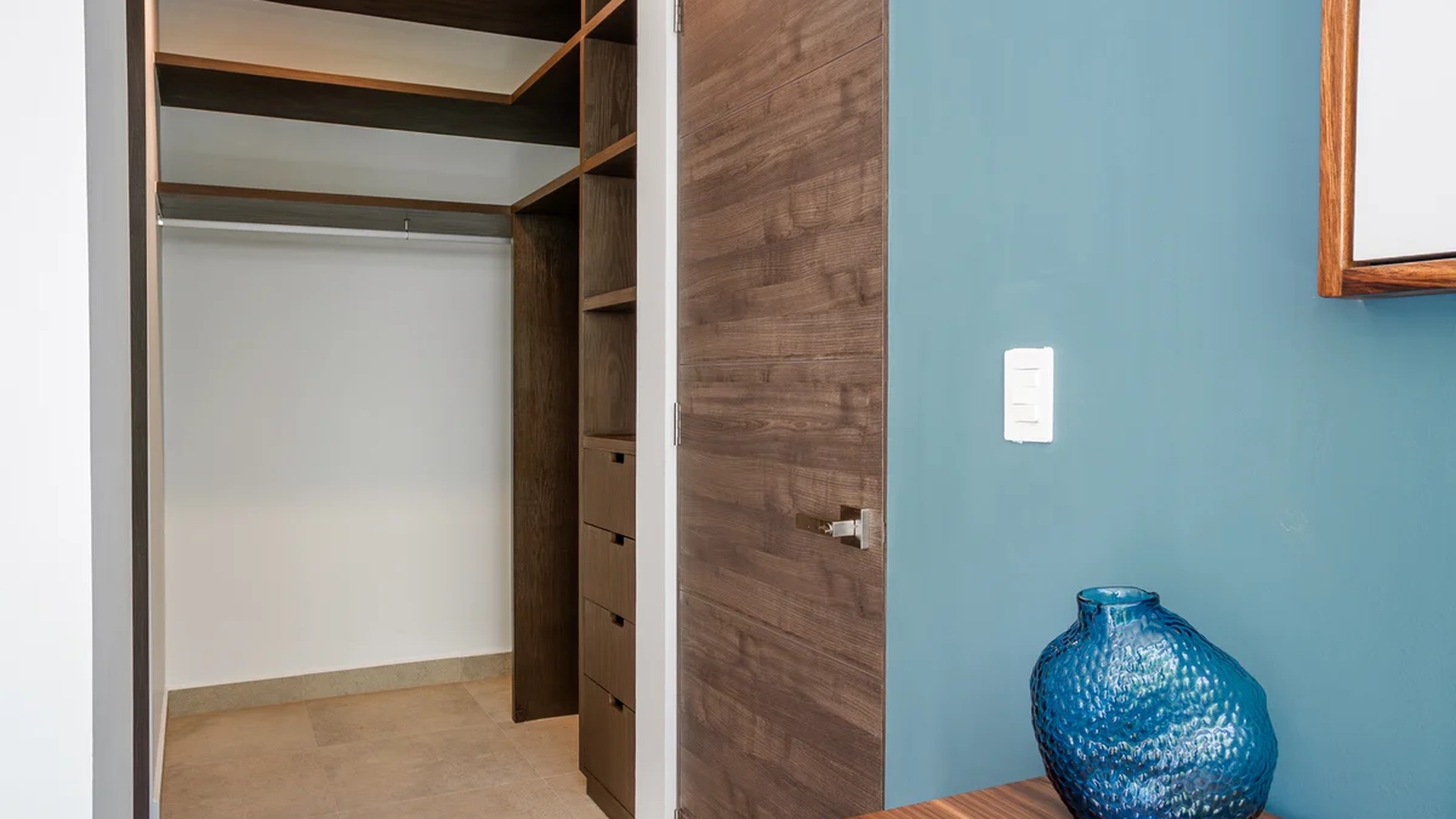 Image of a Walk-In Closet, featuring Custom Cabinetry and Wood Finishes.