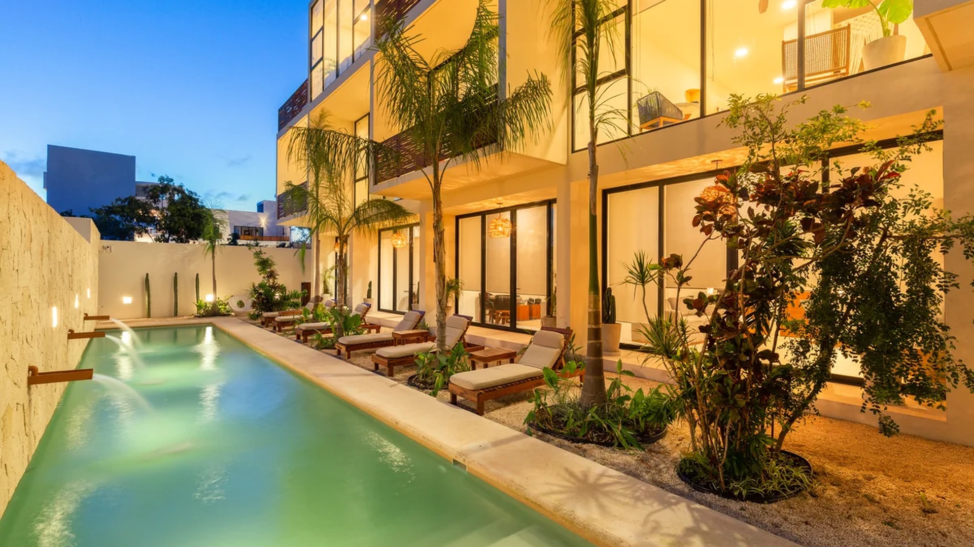 Image of a Resort-Style Pool, featuring Tropical Landscaping and Modern Architecture.