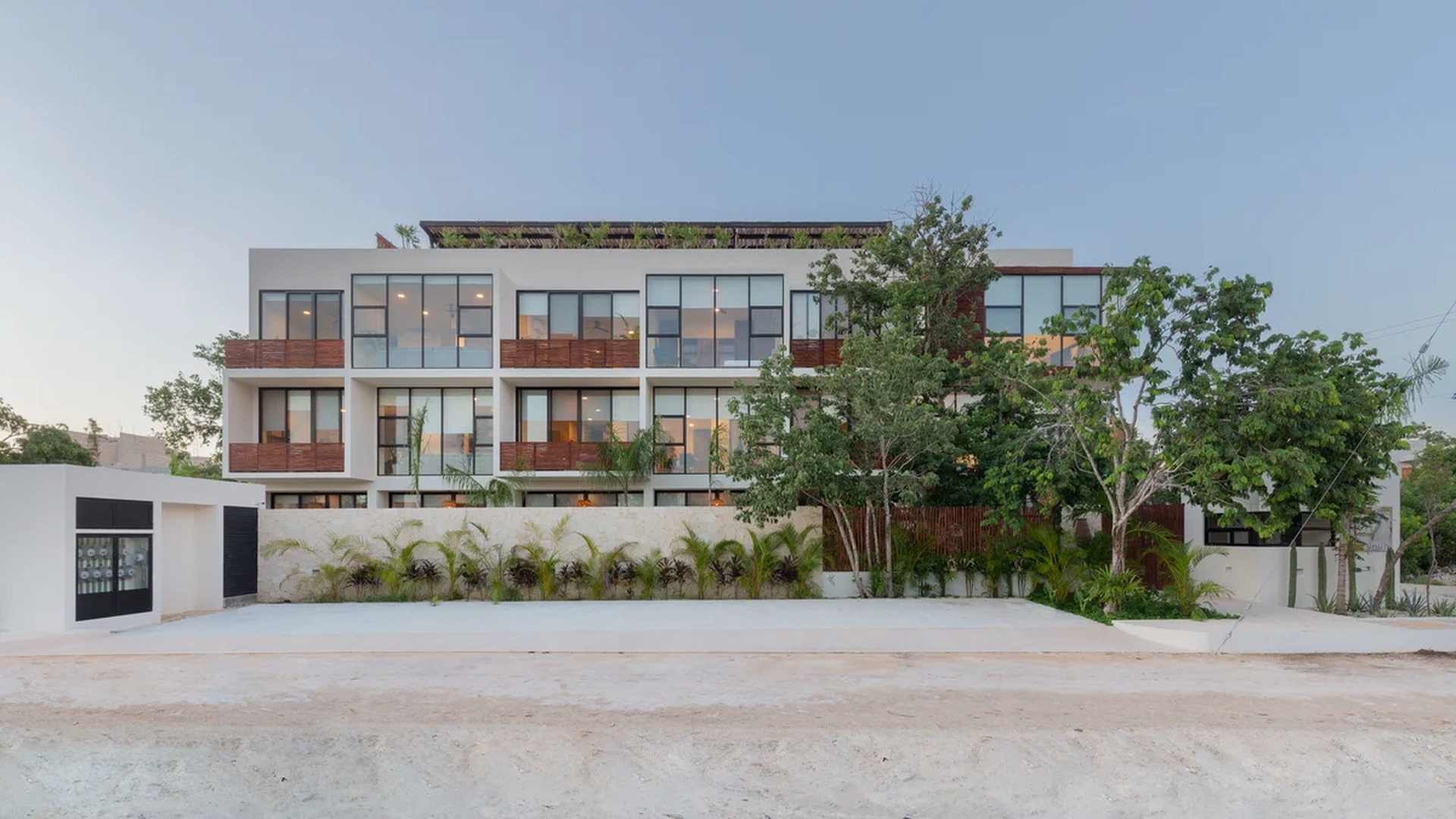 Image of a Modern Apartment Building, featuring Floor-to-Ceiling Windows and Private Balconies.