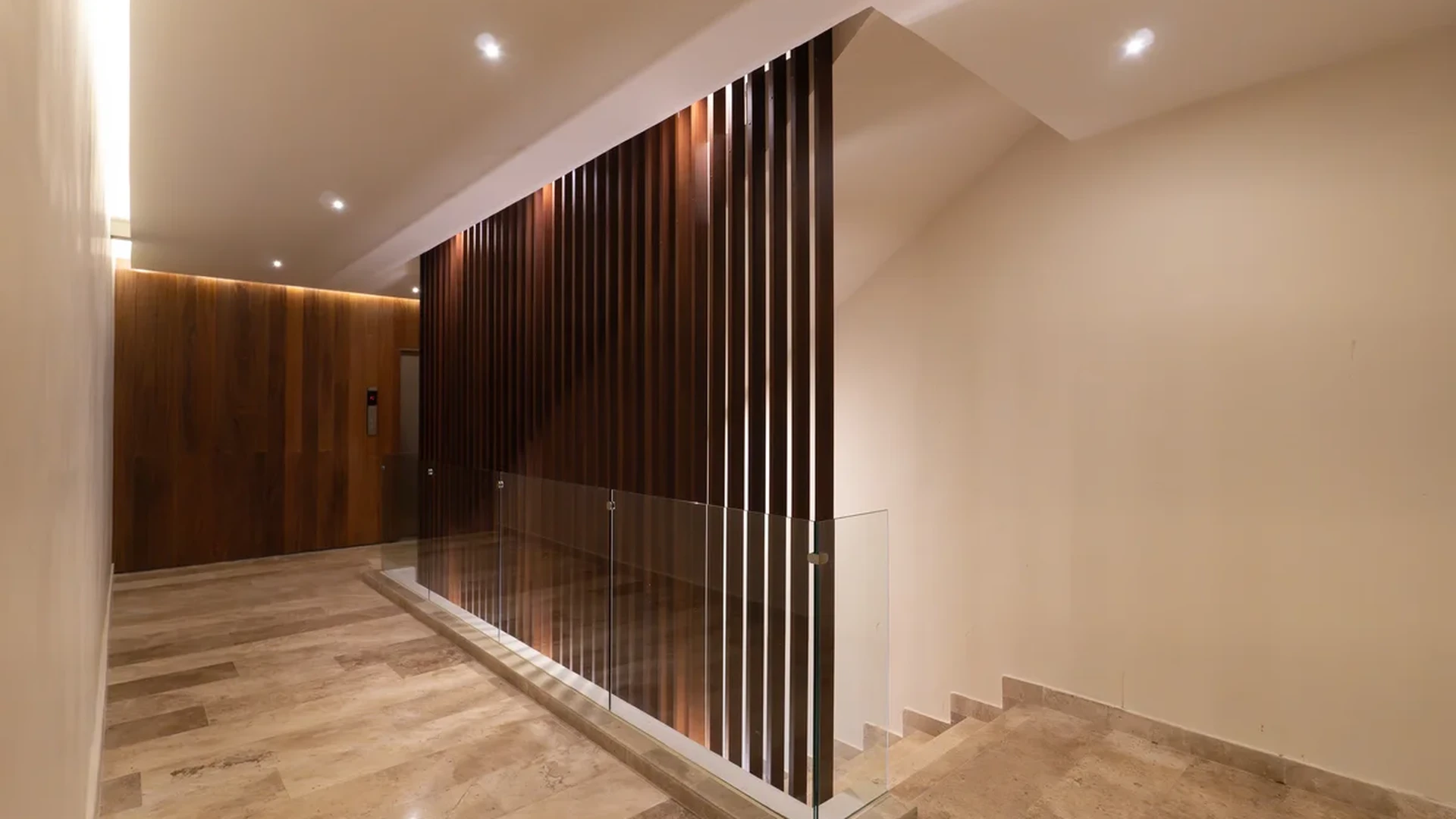 Image of a Contemporary Lobby, featuring Wood Paneling and Travertine Flooring.