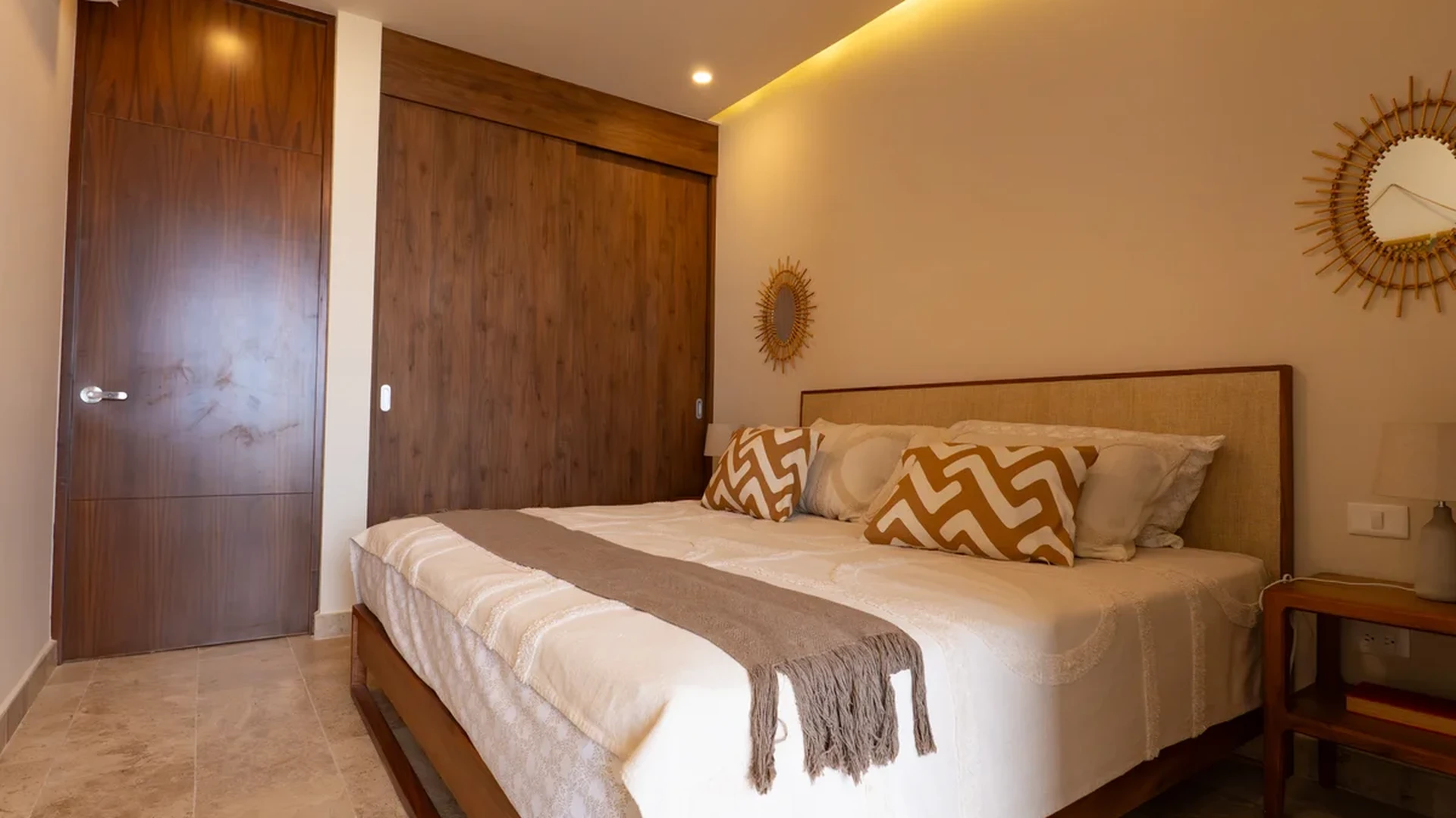 Image of a Master Bedroom, featuring Wood Cabinetry and Travertine Tile Flooring.