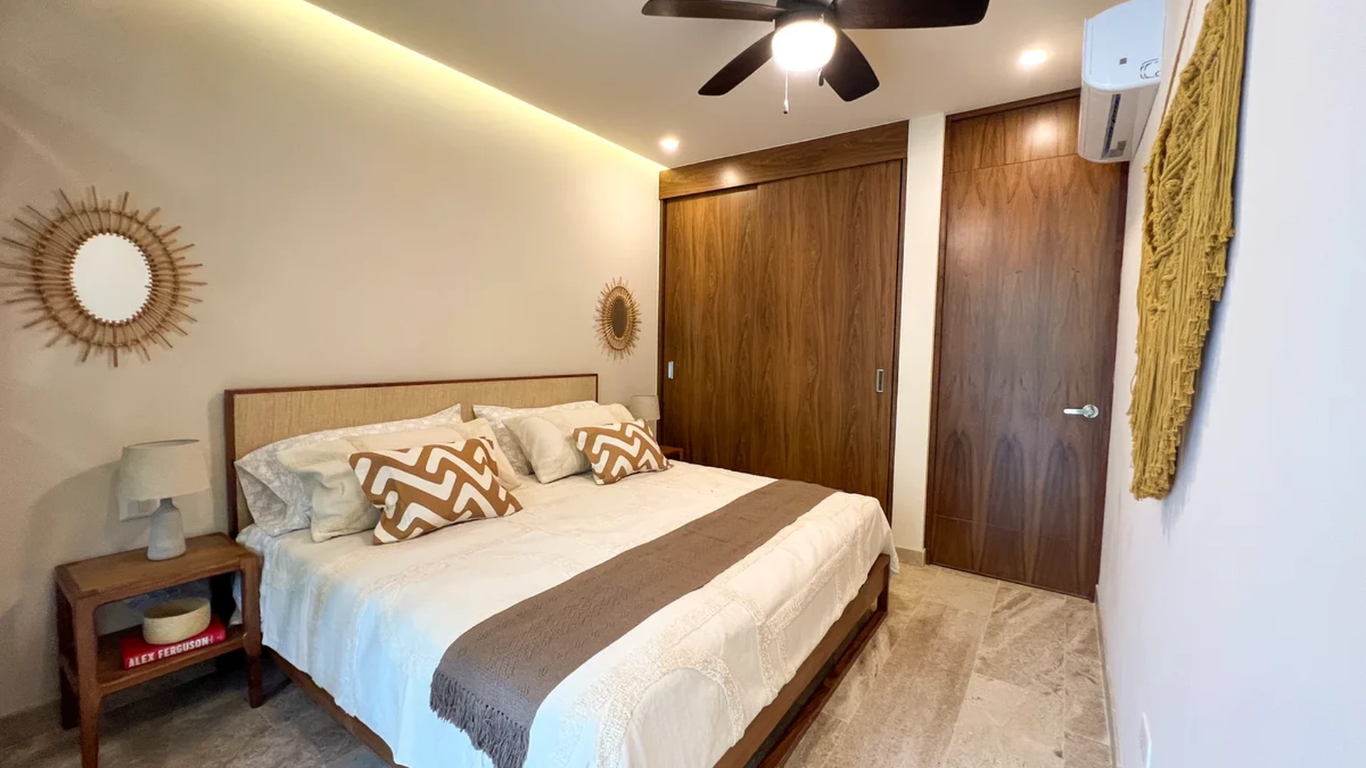 Image of a Master Bedroom, featuring Stone Tile Flooring and Built-in Wooden Closets.