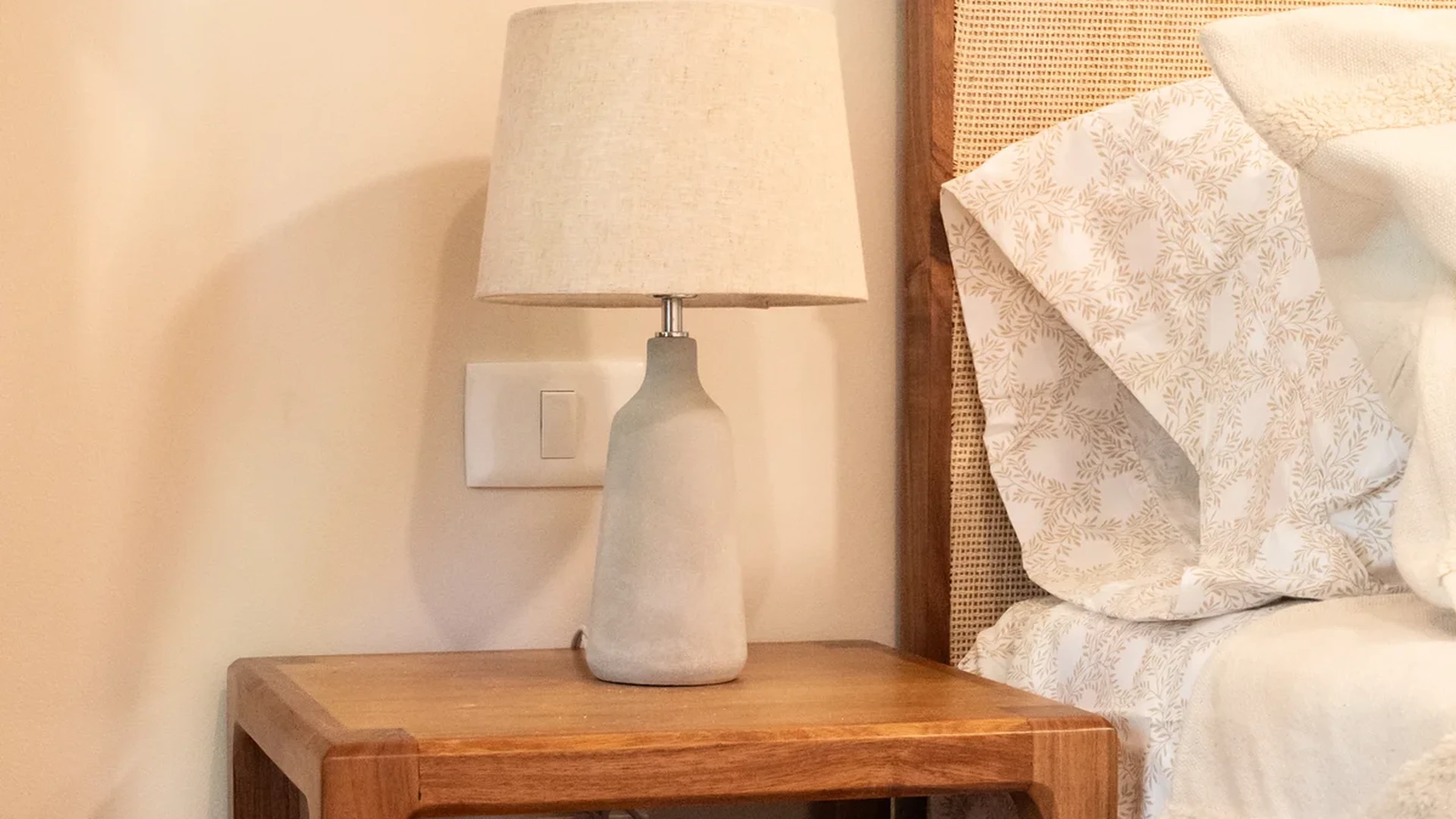 Image of a Styled Bedroom, featuring Cane Headboard and Wooden Furniture.