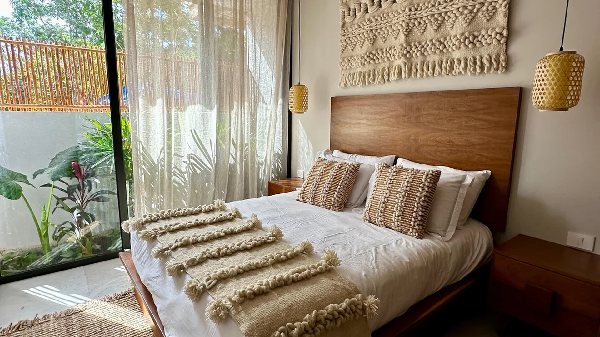 Image of a Primary Bedroom, featuring Boho Chic Decor and Sliding Glass Doors.