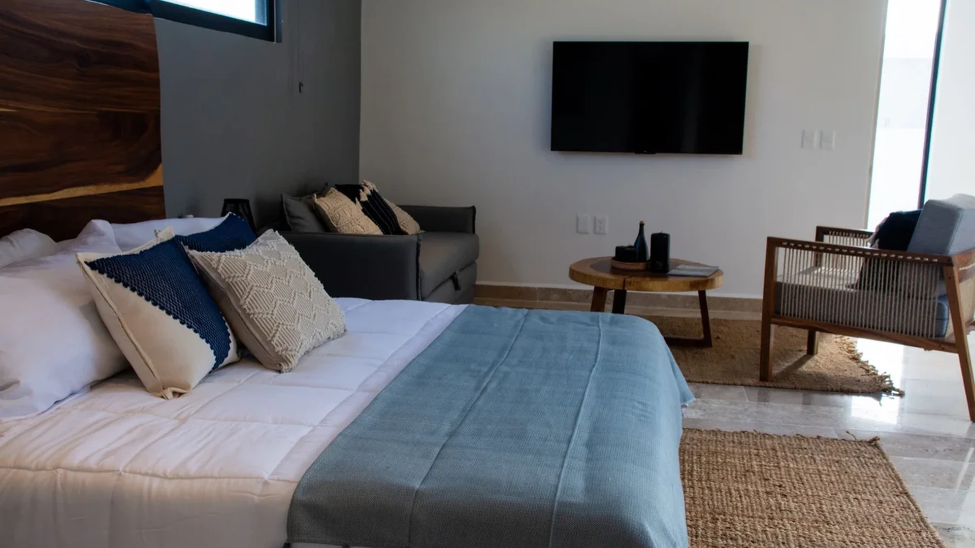Image of a Studio Apartment, featuring Modern Decor and Live-Edge Wood Headboard.