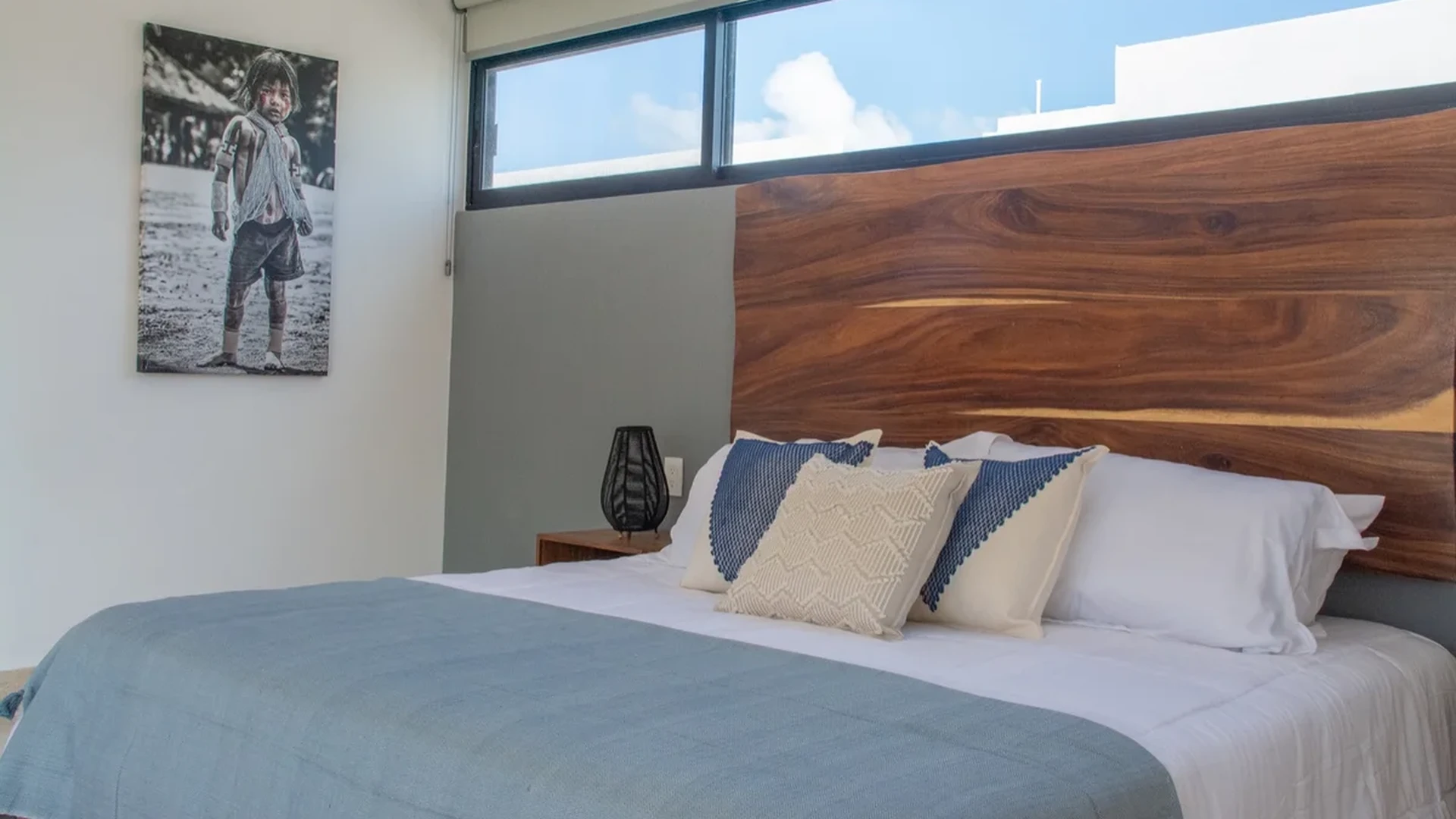 Image of a Modern Bedroom, featuring Wood Grain Headboard and Accent Wall.