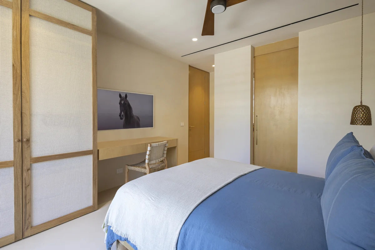 Image of a Modern Bedroom, featuring Minimalist Design and Built-in Desk.