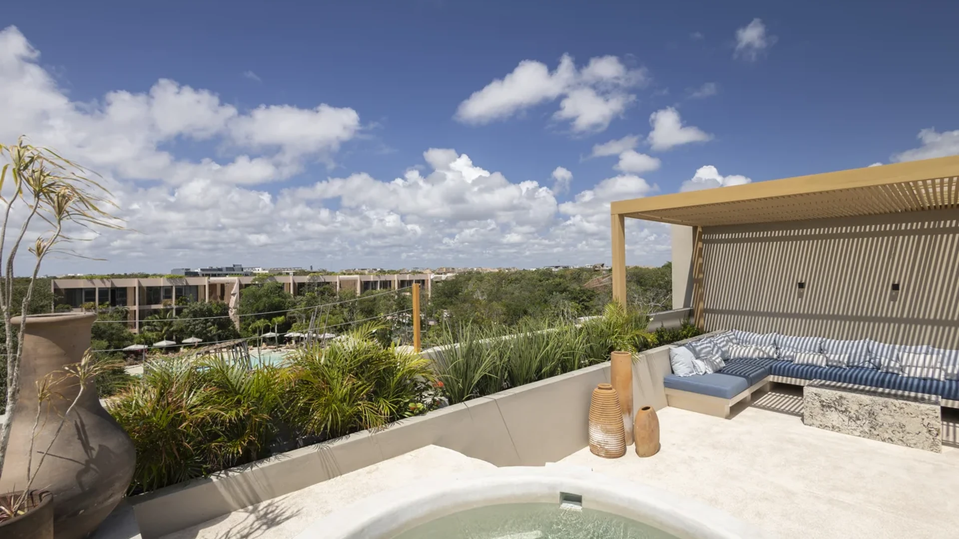 Image of a Rooftop Terrace, featuring Private Jacuzzi and Covered Pergola Lounge.