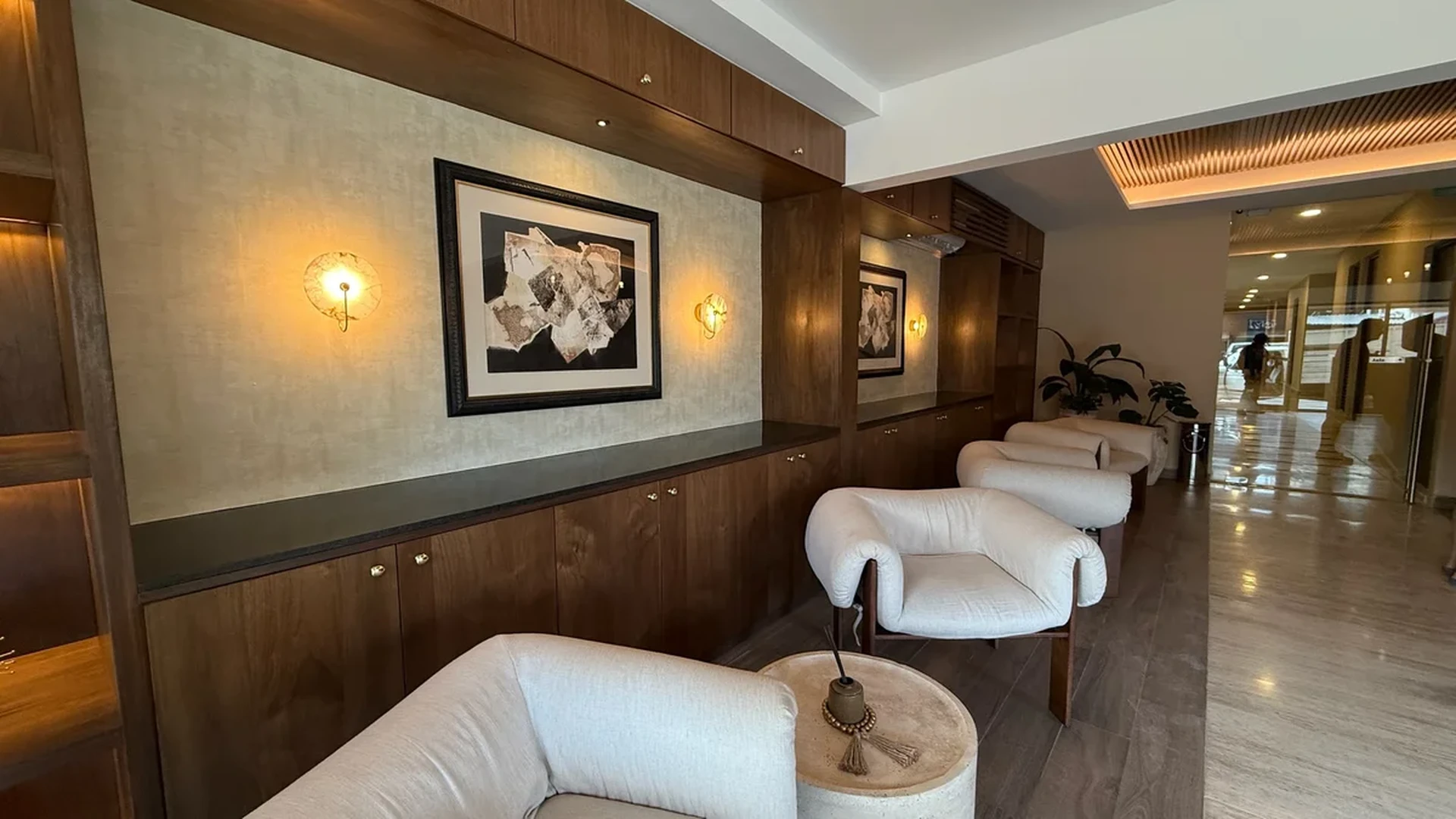 Image of a Lobby Seating Area, featuring Custom Wood Cabinetry and Marble Flooring.