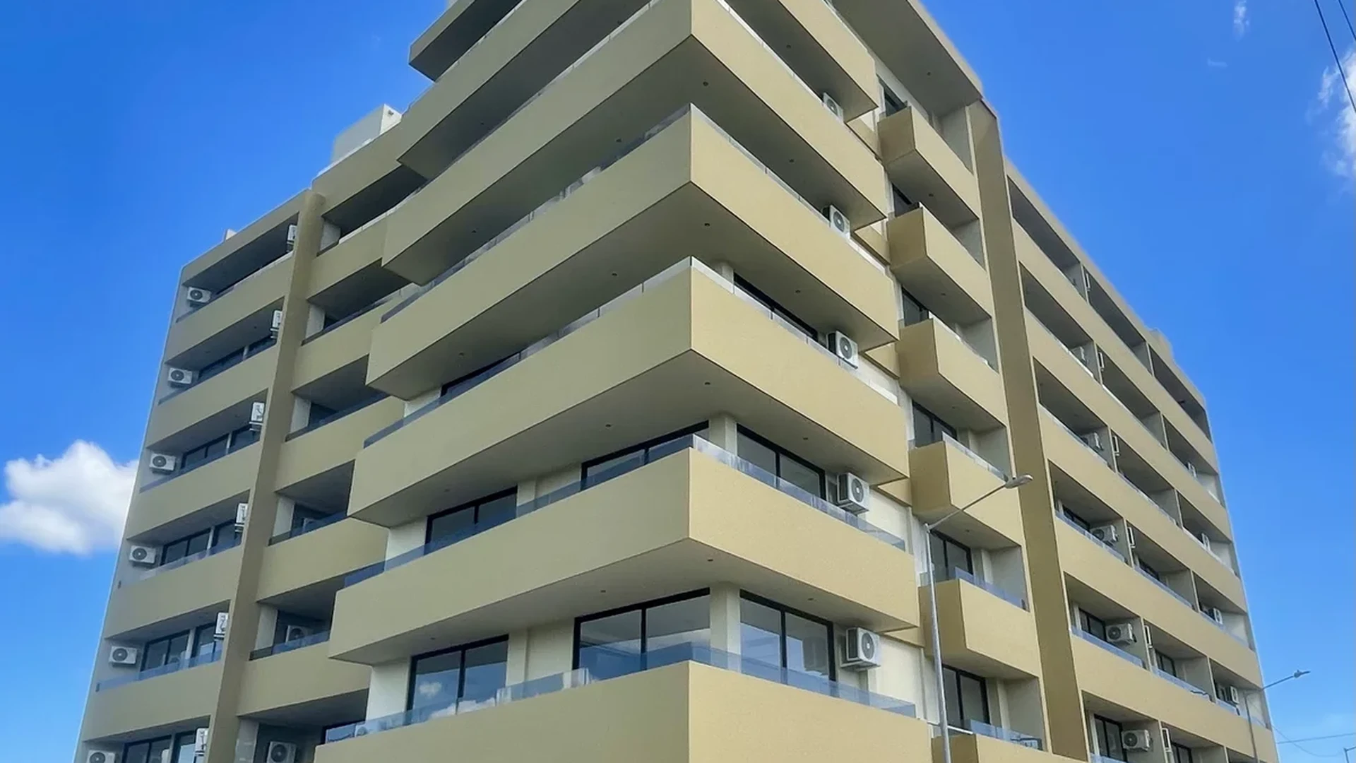 Image of a Modern Apartment Building, featuring Contemporary Architecture and Private Balconies.