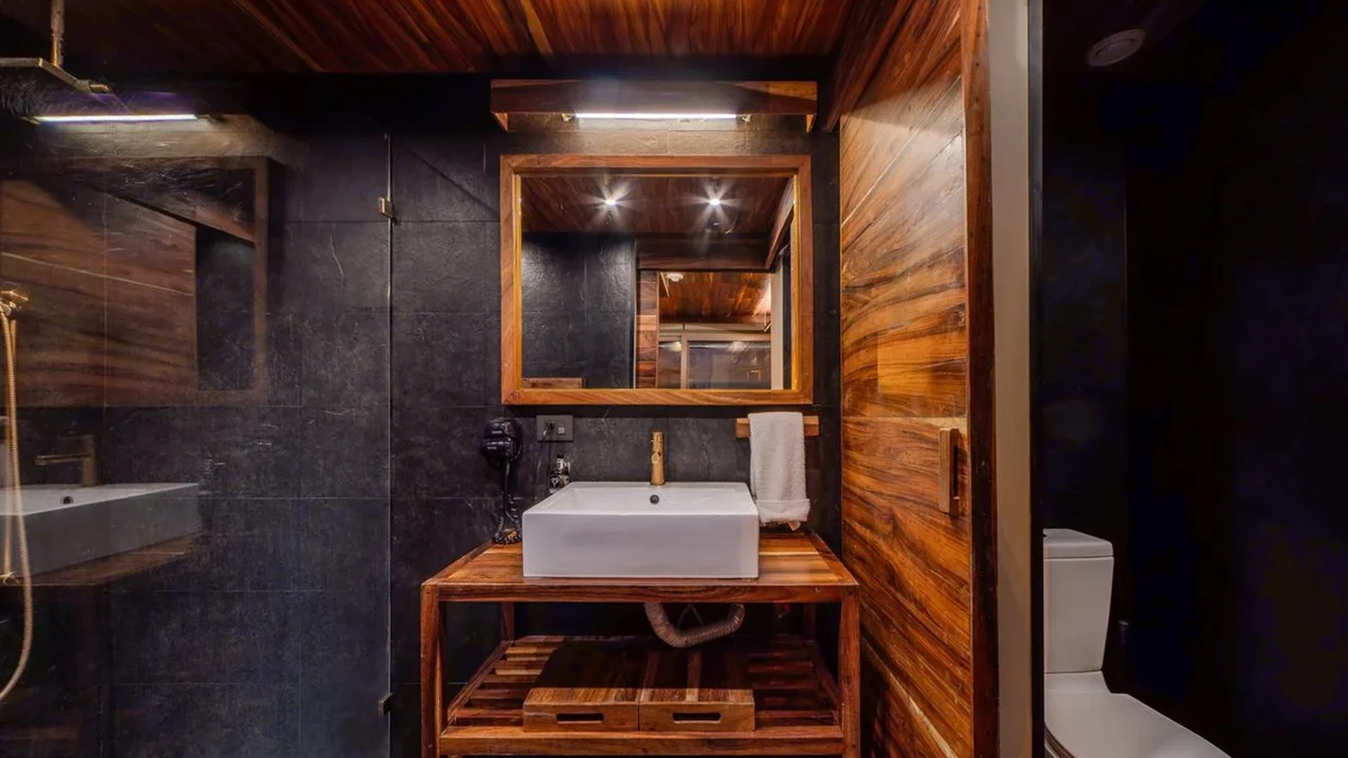 Image of a Modern Bathroom, featuring Wood Paneling and Slate Tile Walls.