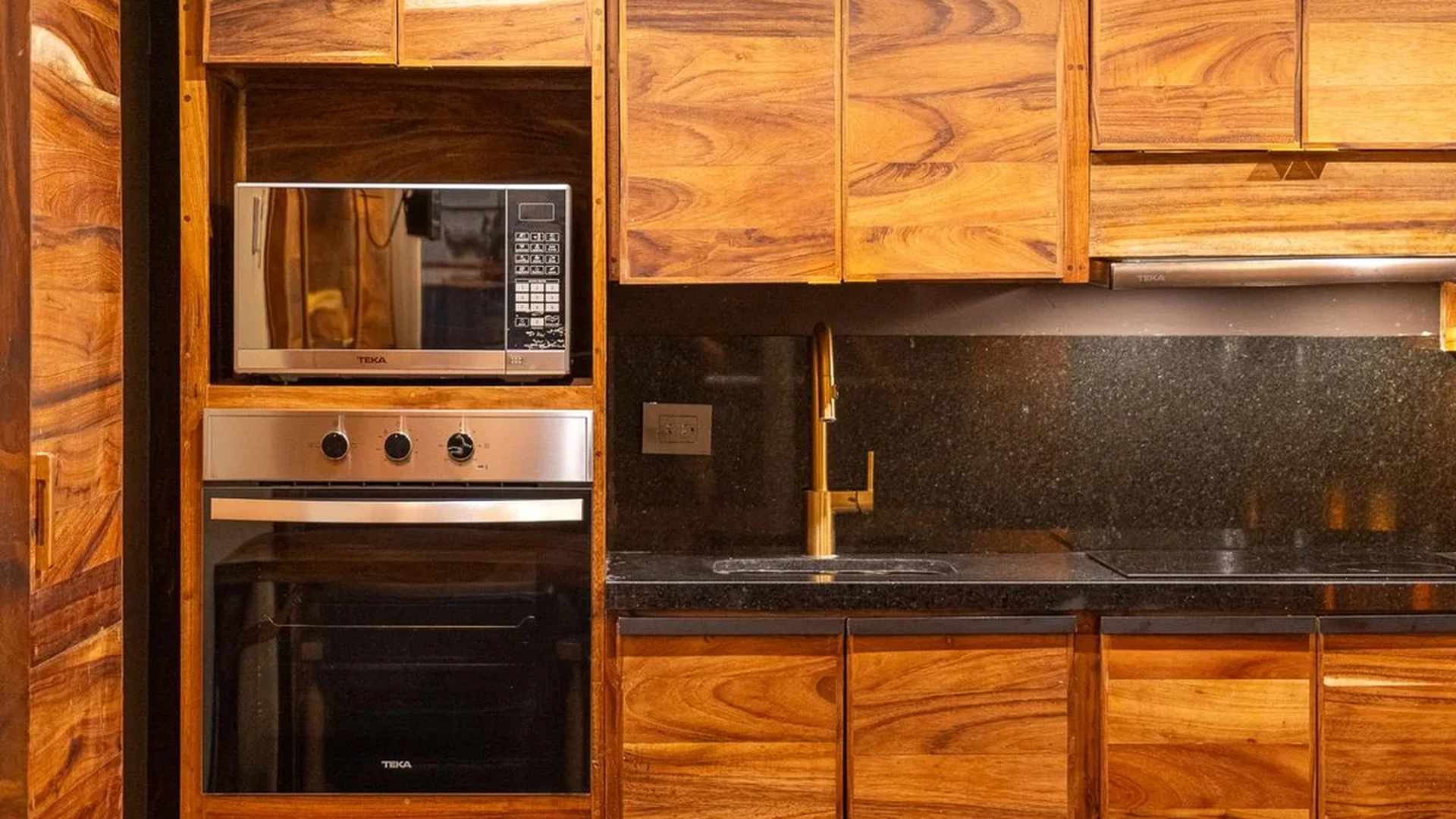 Image of a Modern Kitchen, featuring Wood Grain Cabinetry and Granite Countertops.
