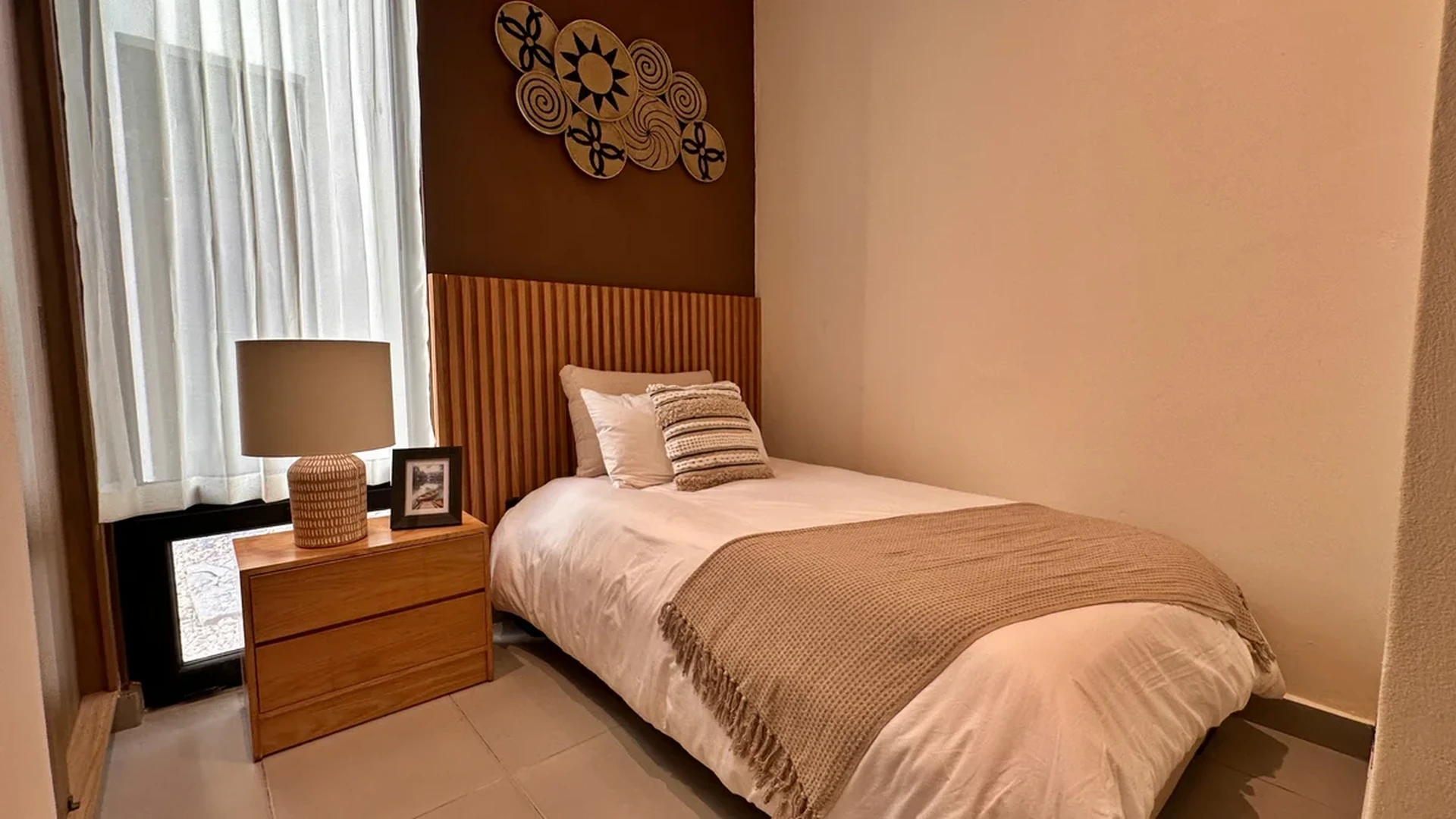 Image of a Bedroom, featuring Wood Slat Headboard and Earthy Color Palette.