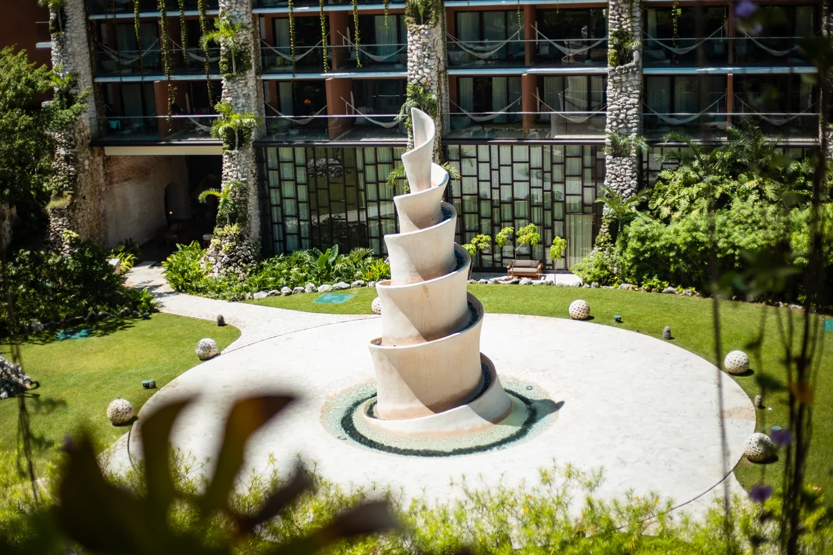 Image of a Courtyard, featuring Lush Garden and Architectural Sculpture.