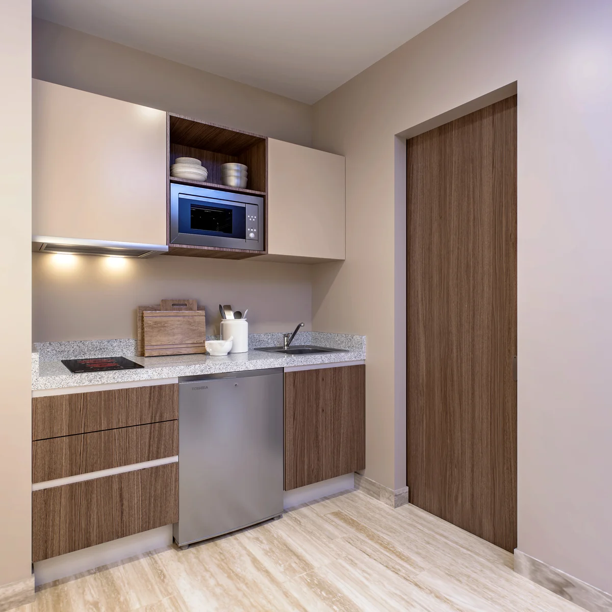 Image of a Kitchenette, featuring Modern Cabinetry and Stone Countertops.