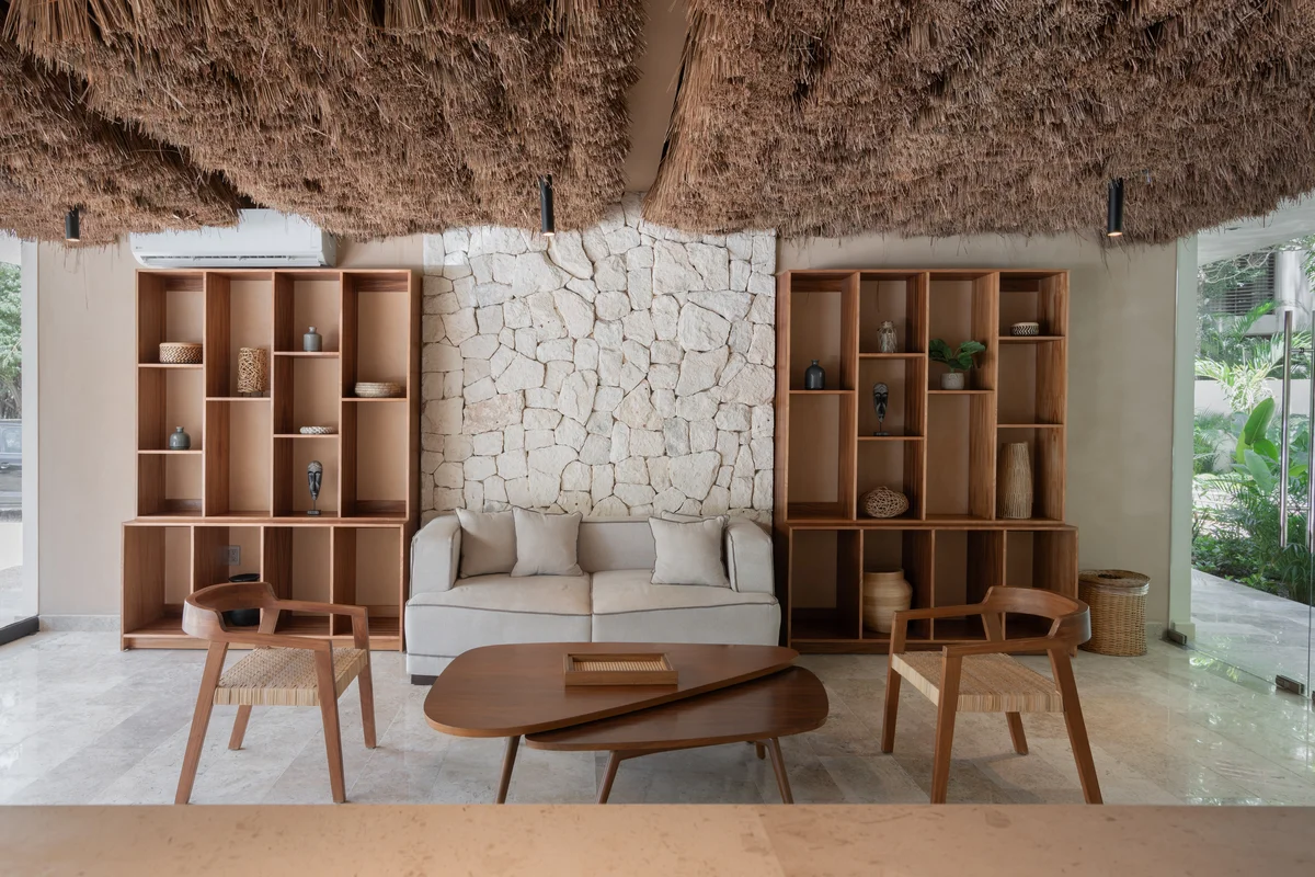Image of a Lobby Lounge, featuring Stone Accent Wall and Custom Built-in Shelving.