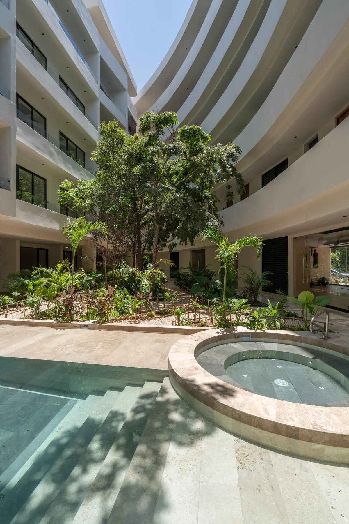 Image of a Resort-Style Courtyard, featuring Modern Architecture and Lush Landscaping.