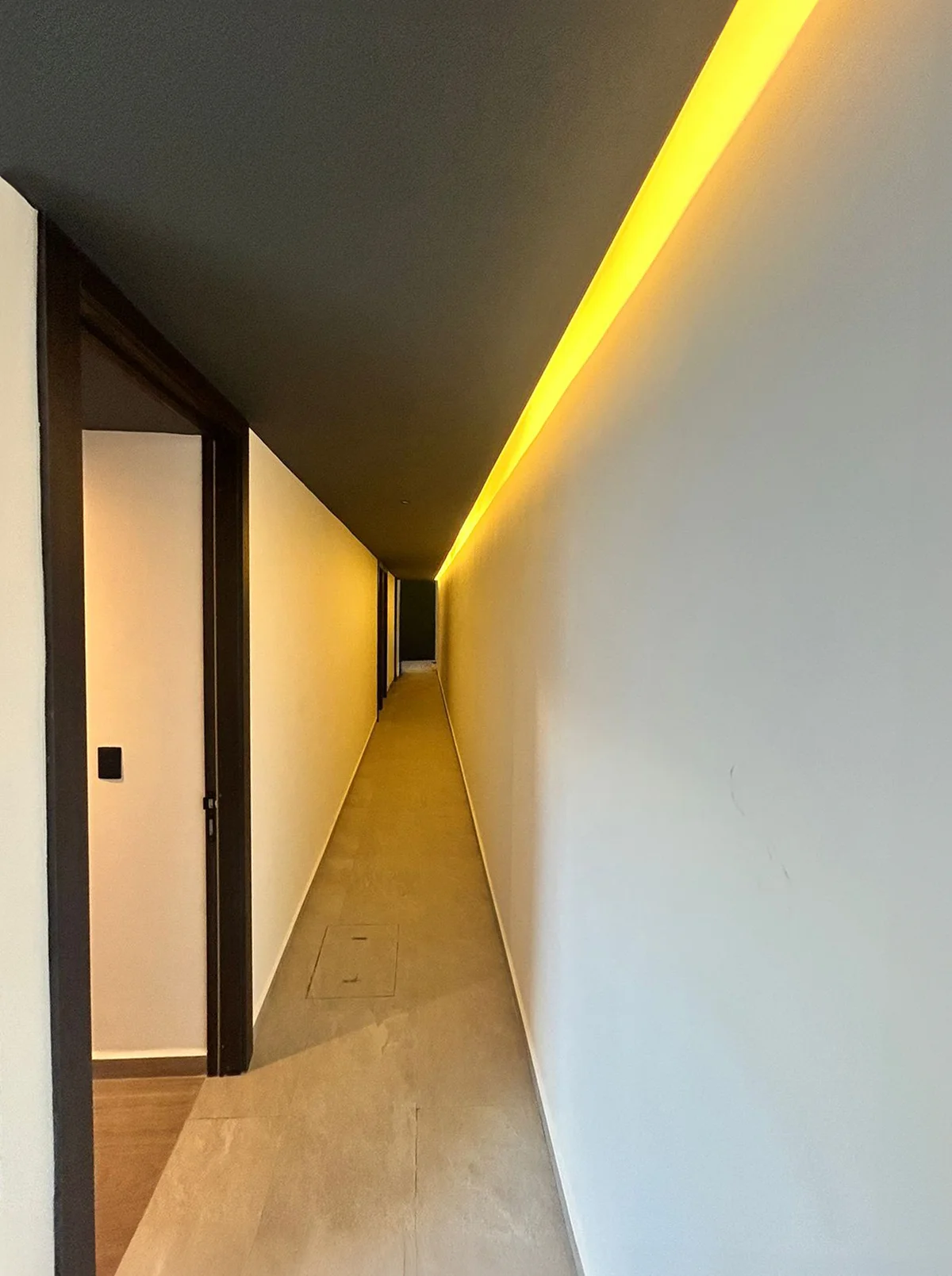 Image of a Modern Hallway, featuring Recessed LED Lighting and Cove Lighting.
