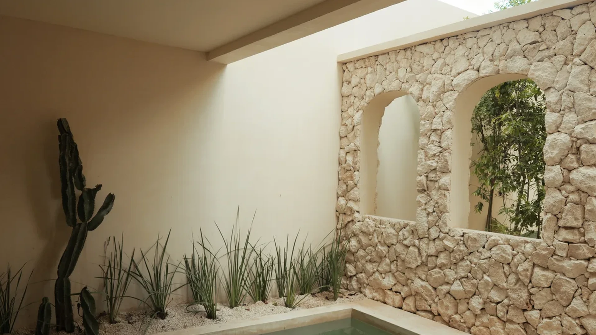Image of a Private Plunge Pool, featuring Stone Accent Wall and Minimalist Courtyard.