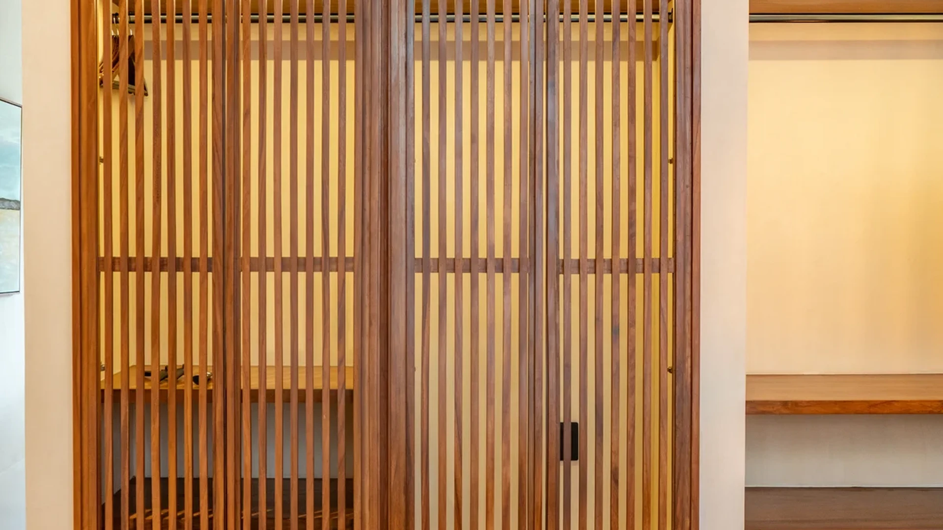 Image of a Modern Bedroom, featuring Slatted Wood Closet and Custom Woodwork.