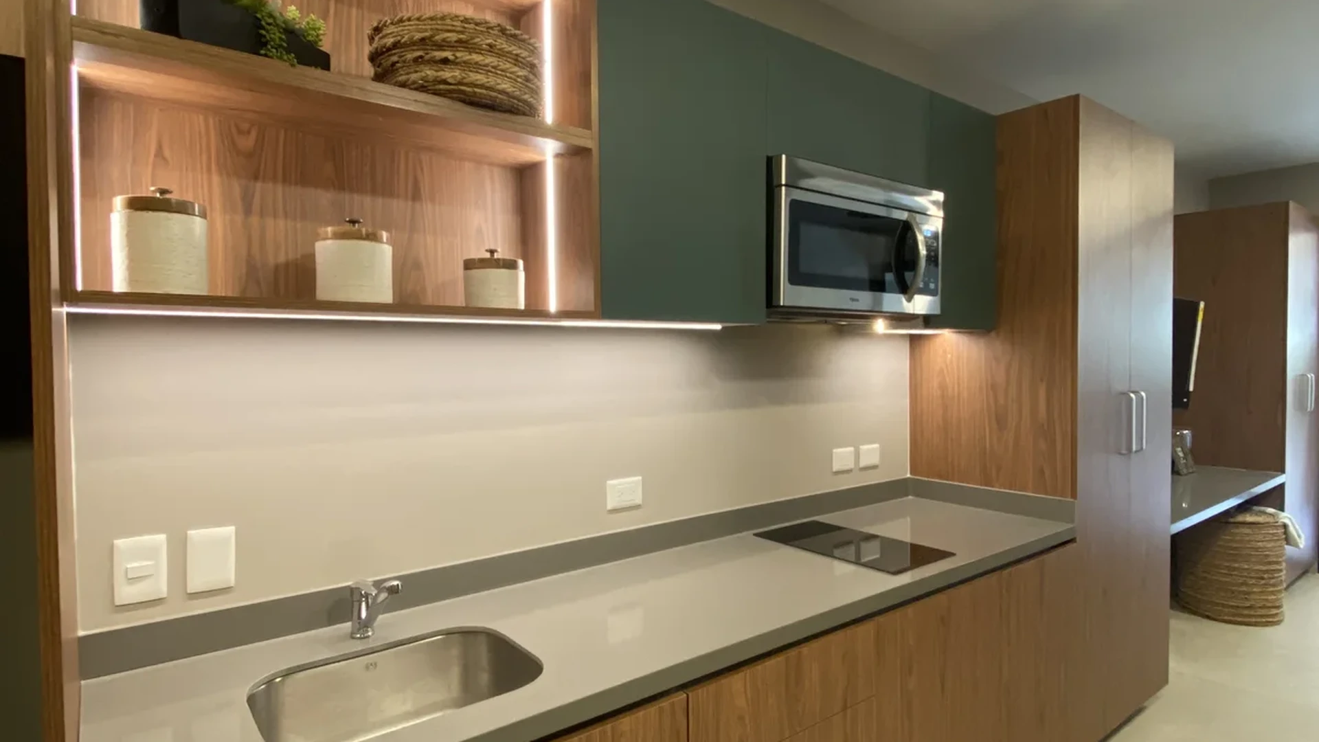 Image of a Modern Kitchenette, featuring Wood-look Cabinetry and Solid Surface Countertops.