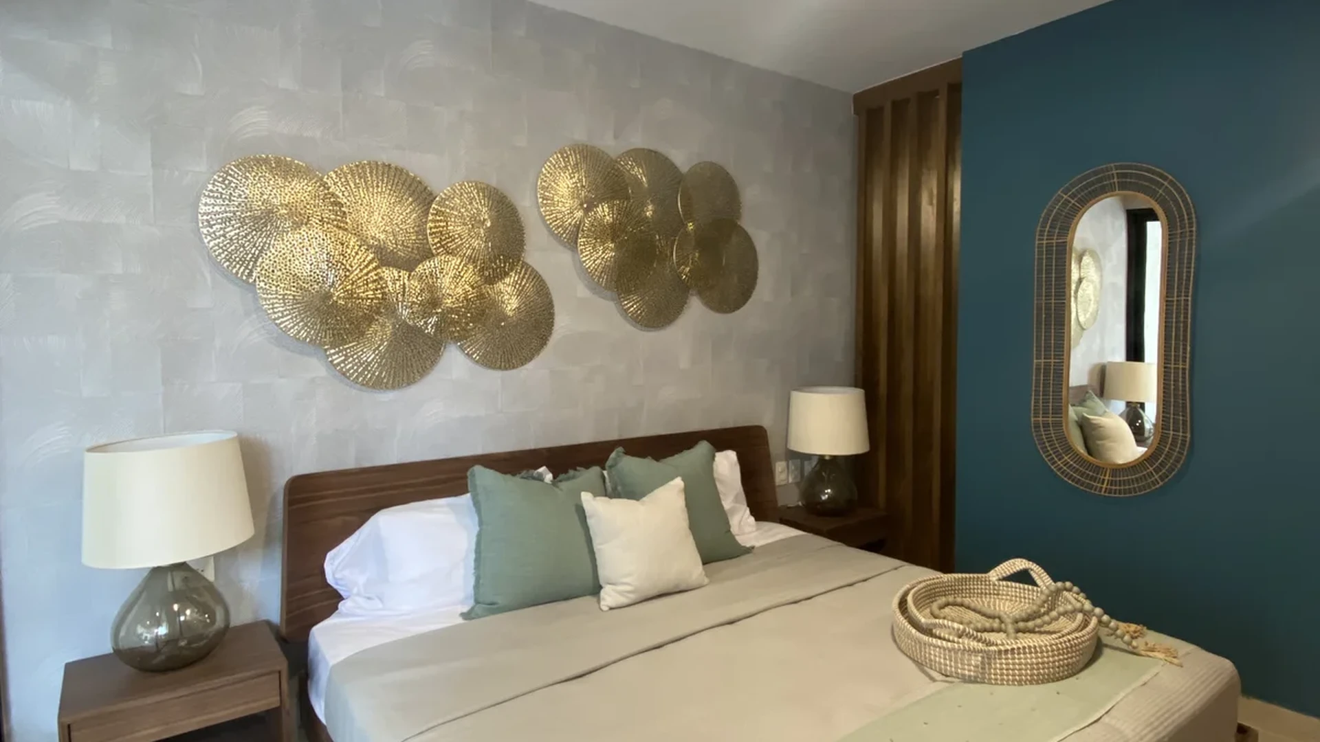 Image of a Master Bedroom, featuring Teal Accent Wall and Gold Wall Decor.