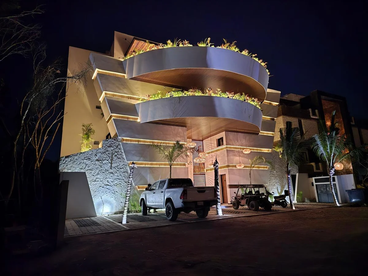 Image of a Architectural Exterior, featuring Modern Condominium and Illuminated Facade.