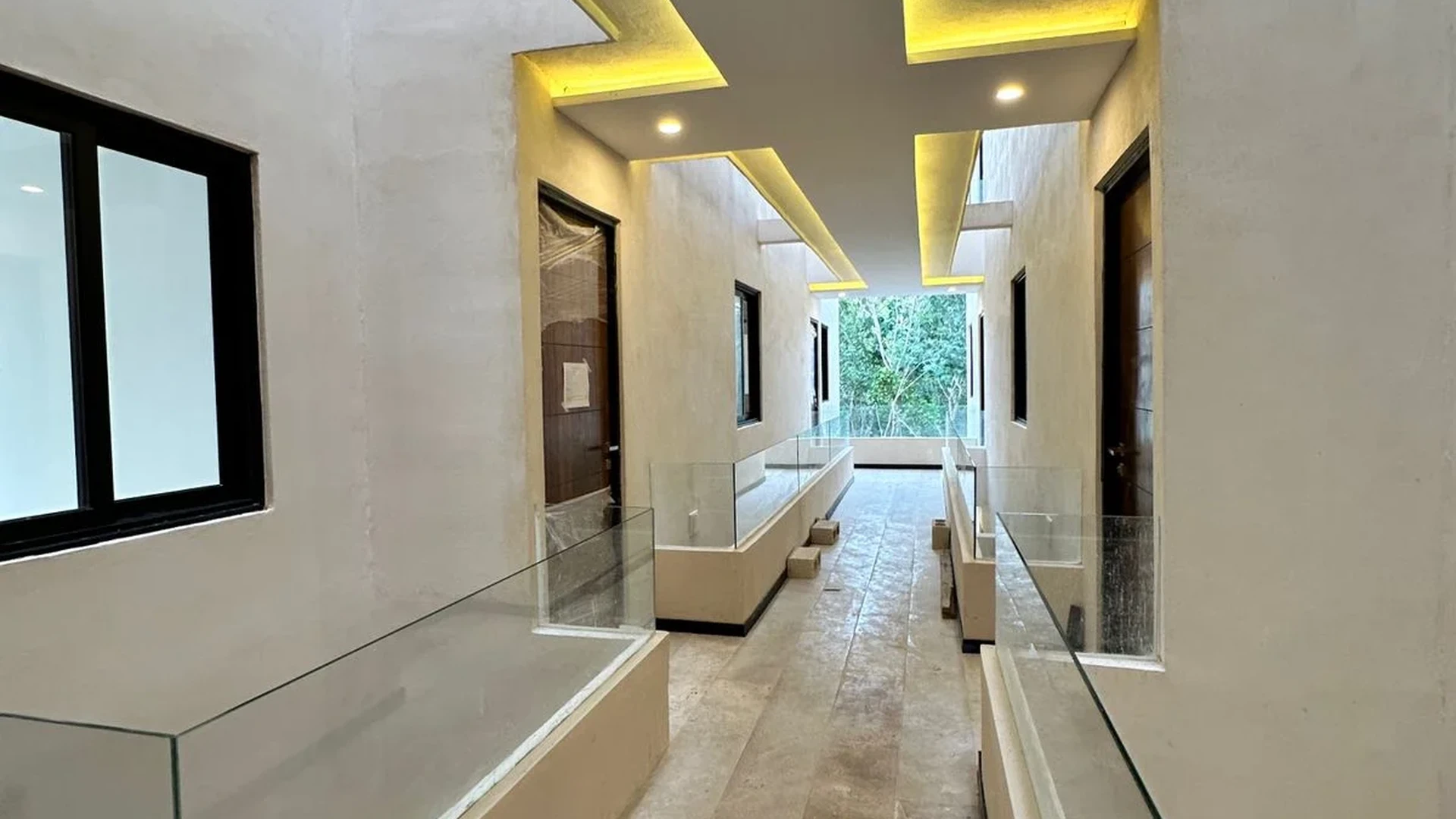 Image of a Modern Hallway, featuring Recessed LED Lighting and Glass Railings.