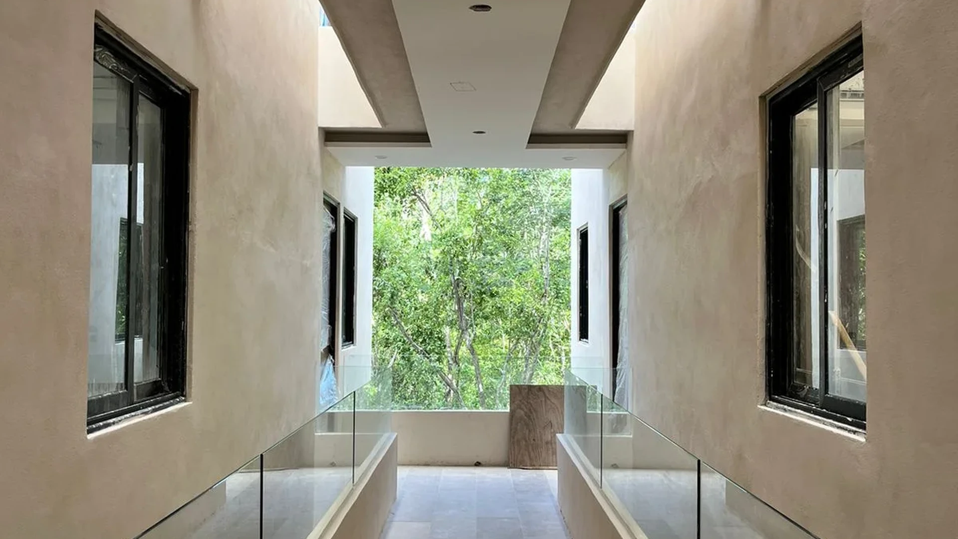 Image of a Modern Corridor, featuring Glass Railings and Open-Air Breezeway.