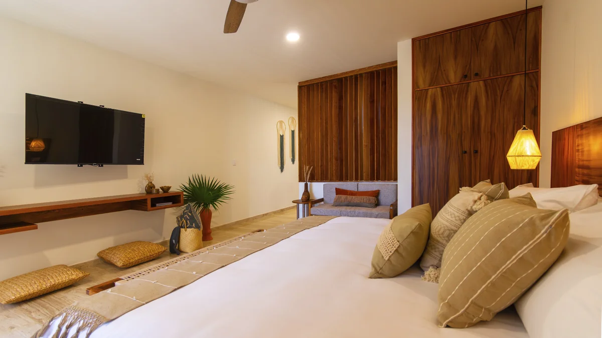 Image of a Bedroom Suite, featuring Hardwood Cabinetry and Seating Area.