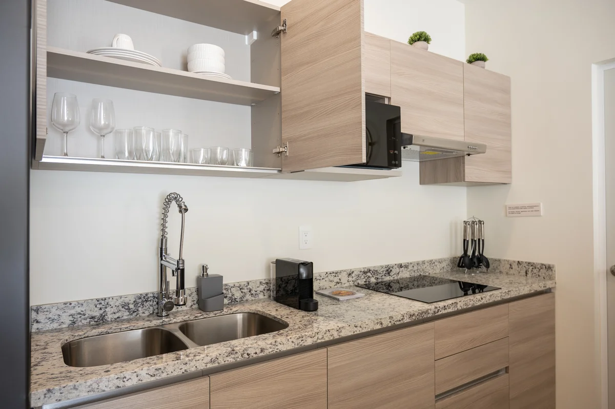 View of Modern Kitchen at Selva Escondida II, showcasing Granite Countertops, Light Wood Cabinets.