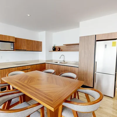 View of Modern Kitchen at Ceiba at 25, showcasing Dining Area, Wood Cabinetry.