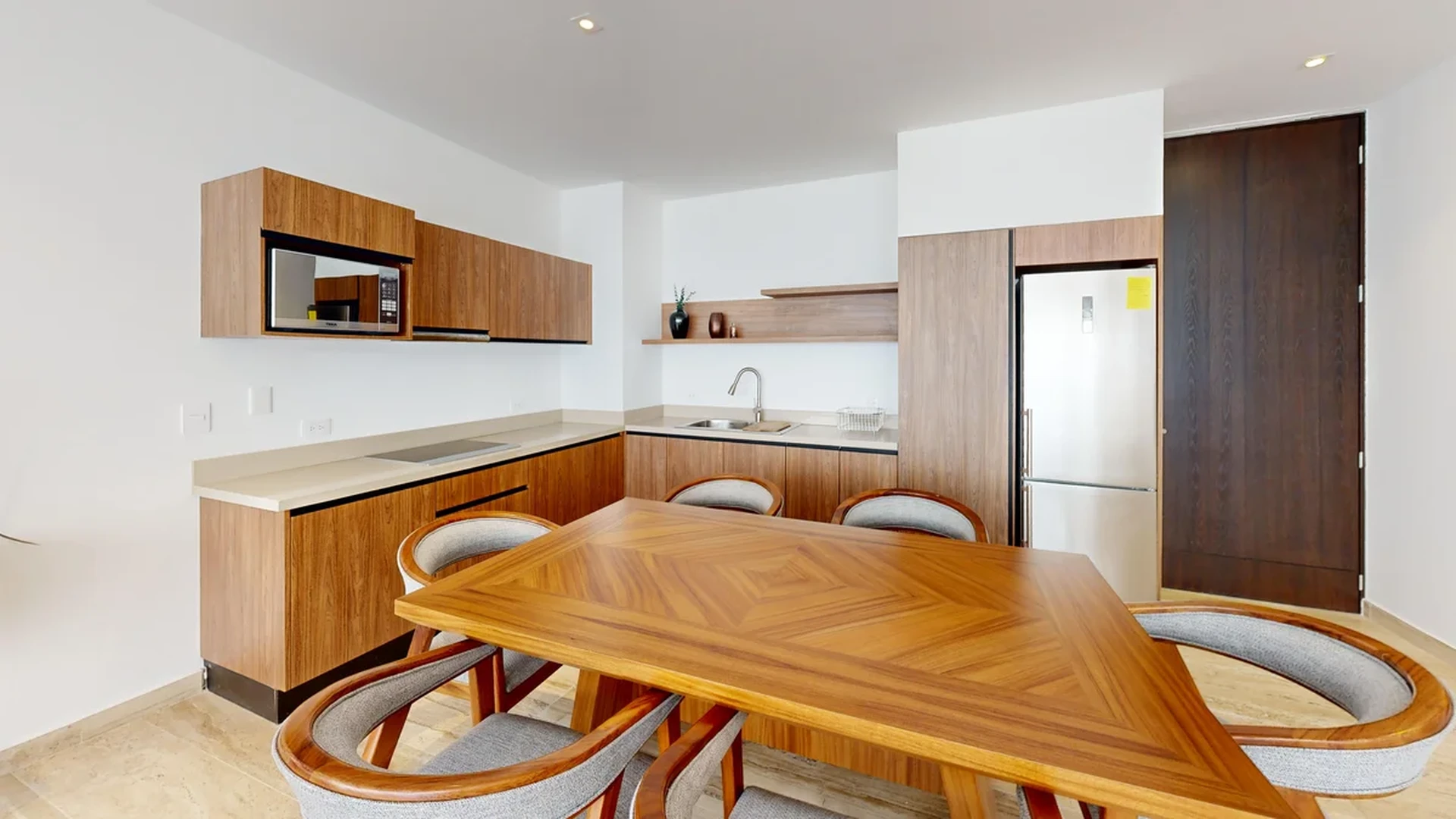 View of Modern Kitchen at Ceiba at 25, showcasing Dining Area, Wood Cabinetry.
