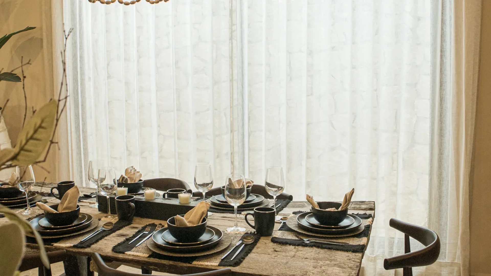 View of Dining Room at Le Reve Cenote, showcasing Rustic Dining Table, Woven Chandelier.
