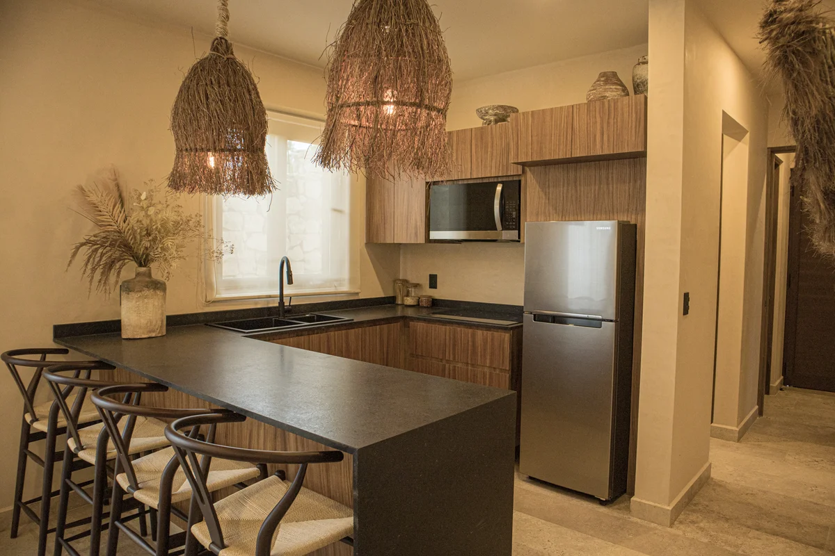 View of Modern Kitchen at Le Reve Cenote, showcasing Breakfast Bar, Boho Design.