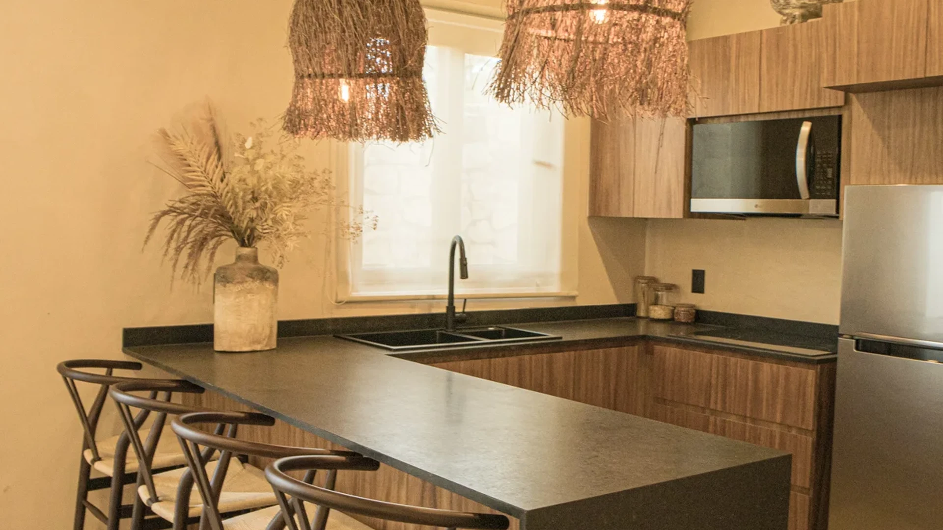 View of Modern Kitchen at Le Reve Cenote, showcasing Breakfast Bar, Boho Lighting.