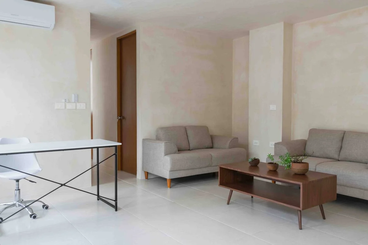 View of Living Room at Menotto 11, showcasing Modern Furniture, Neutral Color Palette.