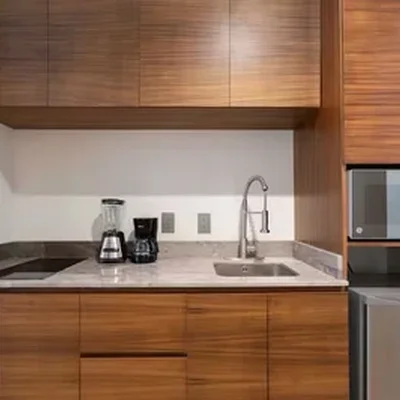 View of Kitchenette at Akua Reserve, showcasing Modern Cabinetry, Wood Finish.