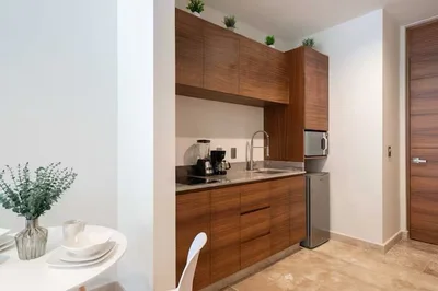 View of Kitchenette at Akua Reserve, showcasing Modern Cabinetry, Wood Cabinets.