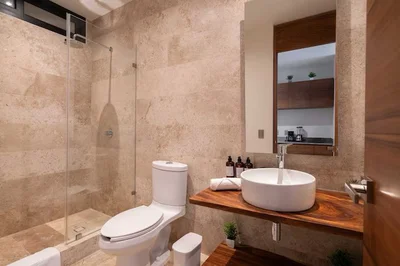 View of Modern Bathroom at Akua Reserve, showcasing Walk-in Shower, Stone Tile.