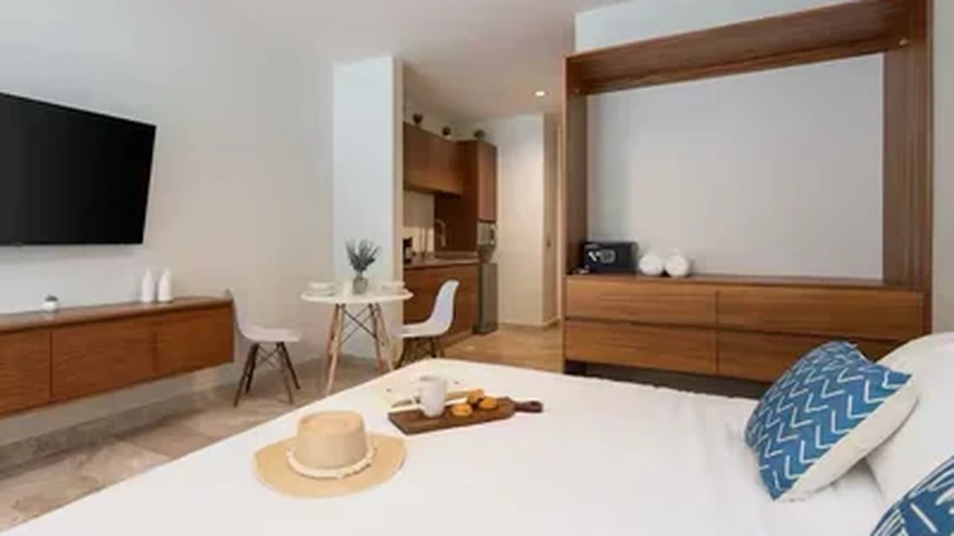 View of Studio Apartment at Akua Reserve, showcasing Modern Design, Wood Furnishings.