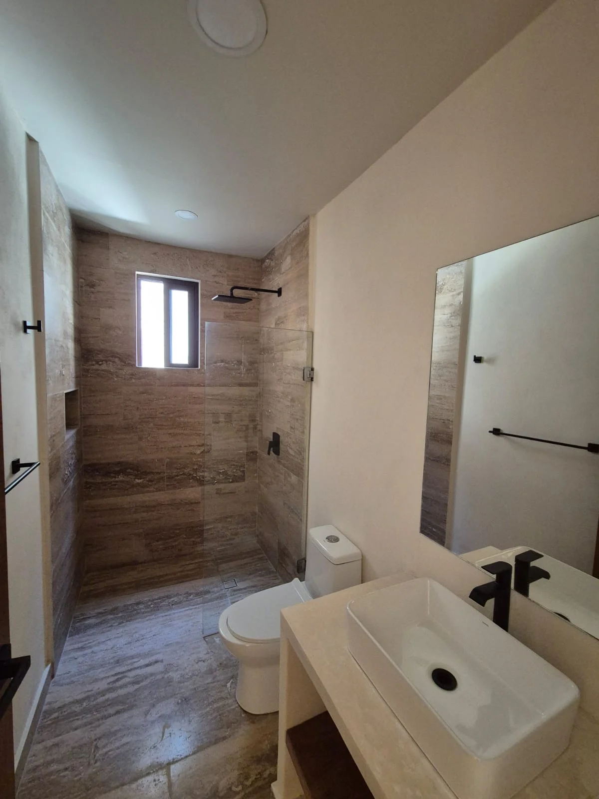 View of Modern Bathroom at Casa Chaak, showcasing Walk-in Shower, Stone Tiling.