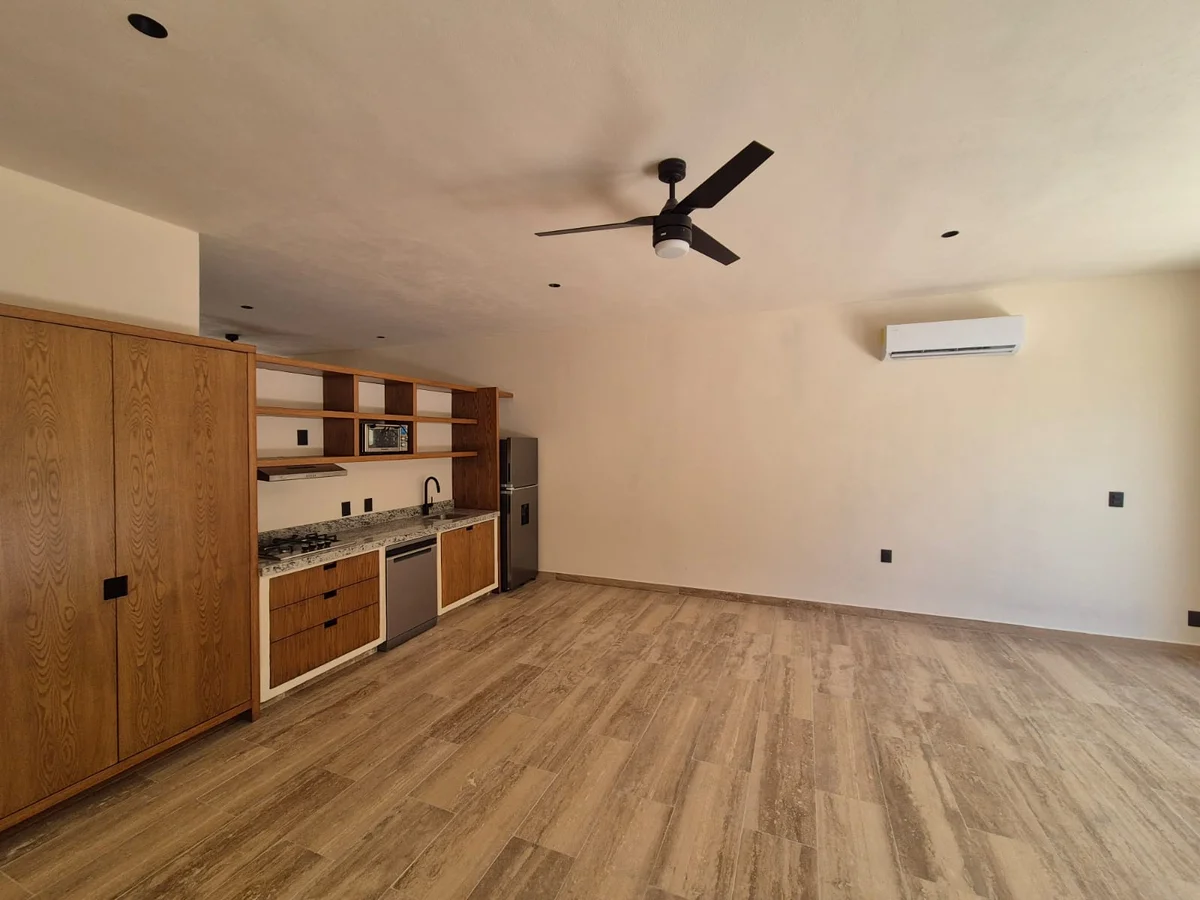 View of Open Concept Living at Casa Chaak, showcasing Modern Kitchenette, Wood-Look Tile Flooring.