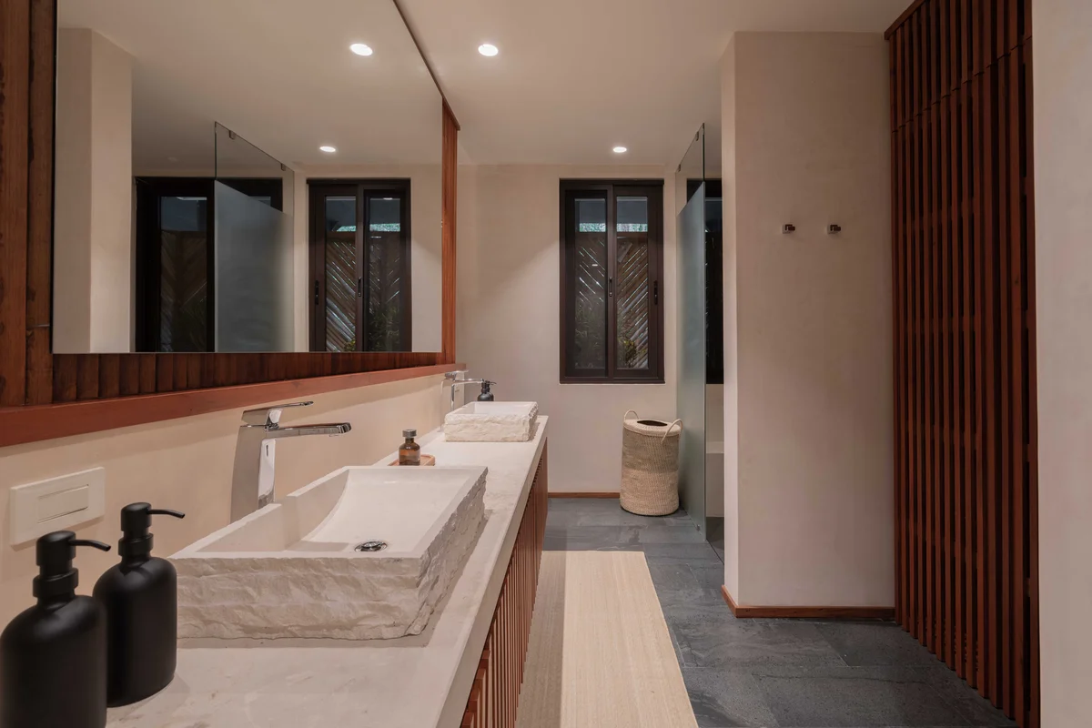 View of Modern Bathroom at Miraluna, showcasing Double Vanity, Stone Vessel Sinks.