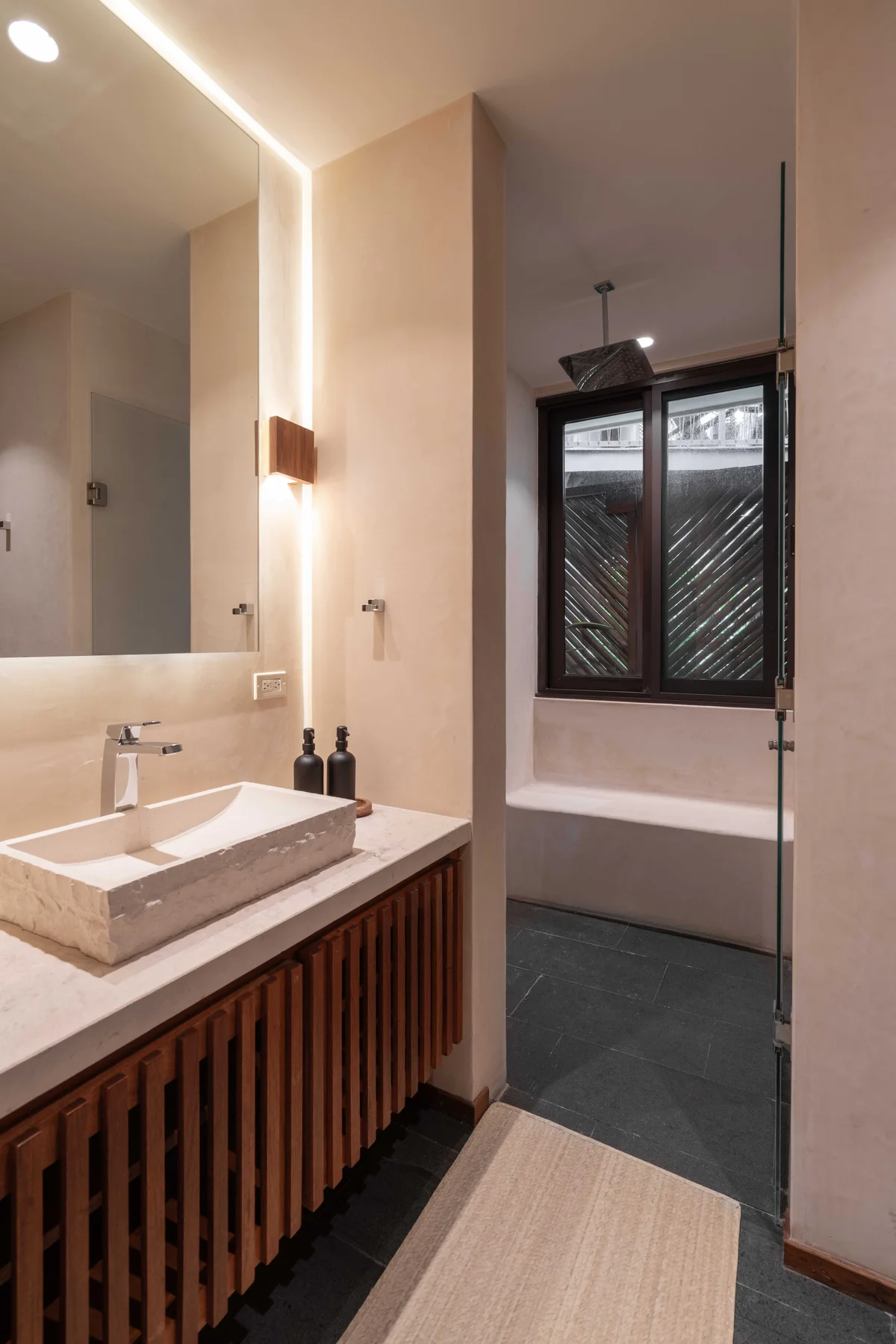 View of Modern Bathroom at Miraluna, showcasing Stone Vessel Sink, Walk-in Shower.