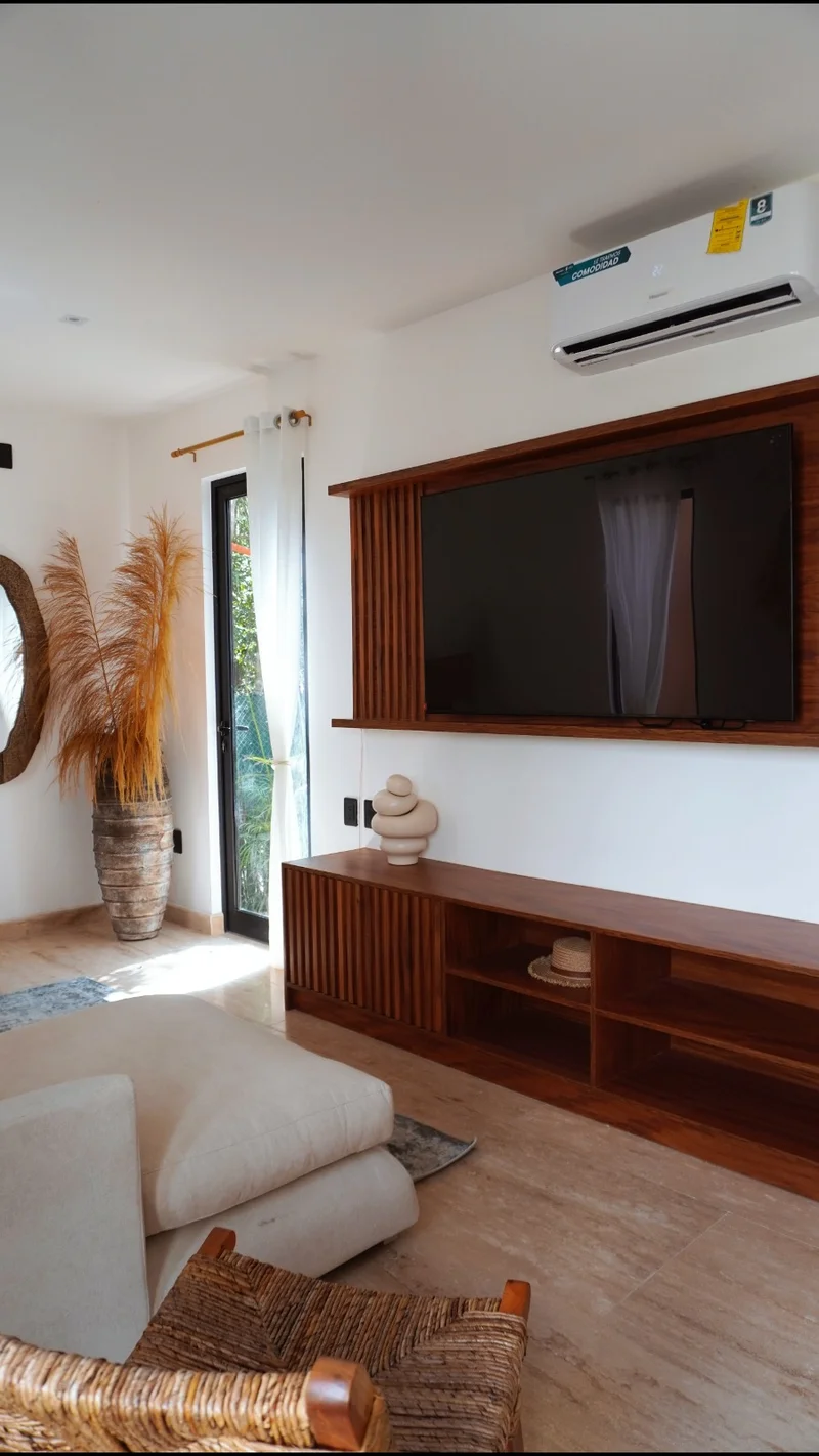View of Modern Living Room at Baikal, showcasing Bohemian Decor, Wood Entertainment Center.