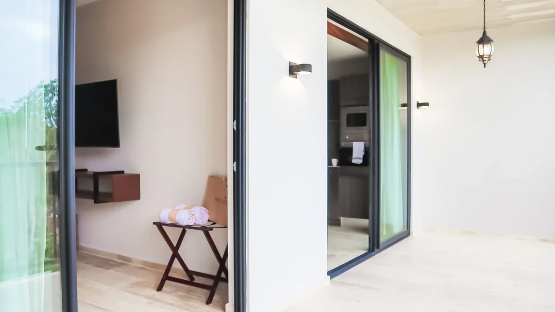 View of Private Balcony at Tuk Hacienda, showcasing Sliding Glass Doors, Indoor-Outdoor Living.