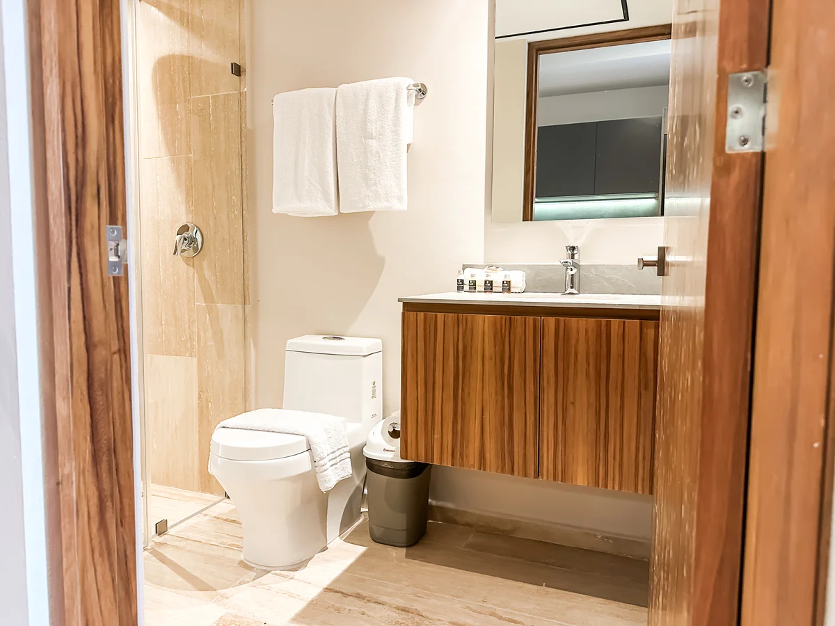 View of Modern Bathroom at Tuk Hacienda, showcasing Wood Vanity, Marble Tiling.